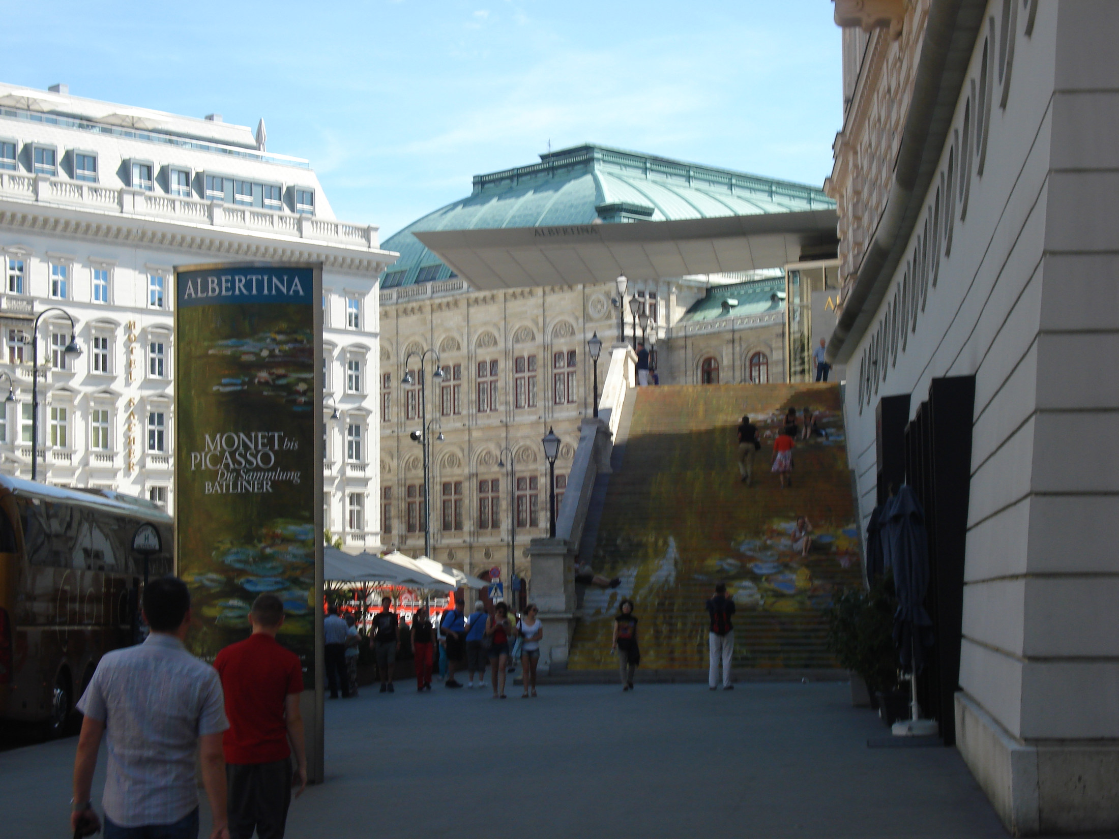 ALBERTINA's street approach and entrance steps with an old Monet exhibition display