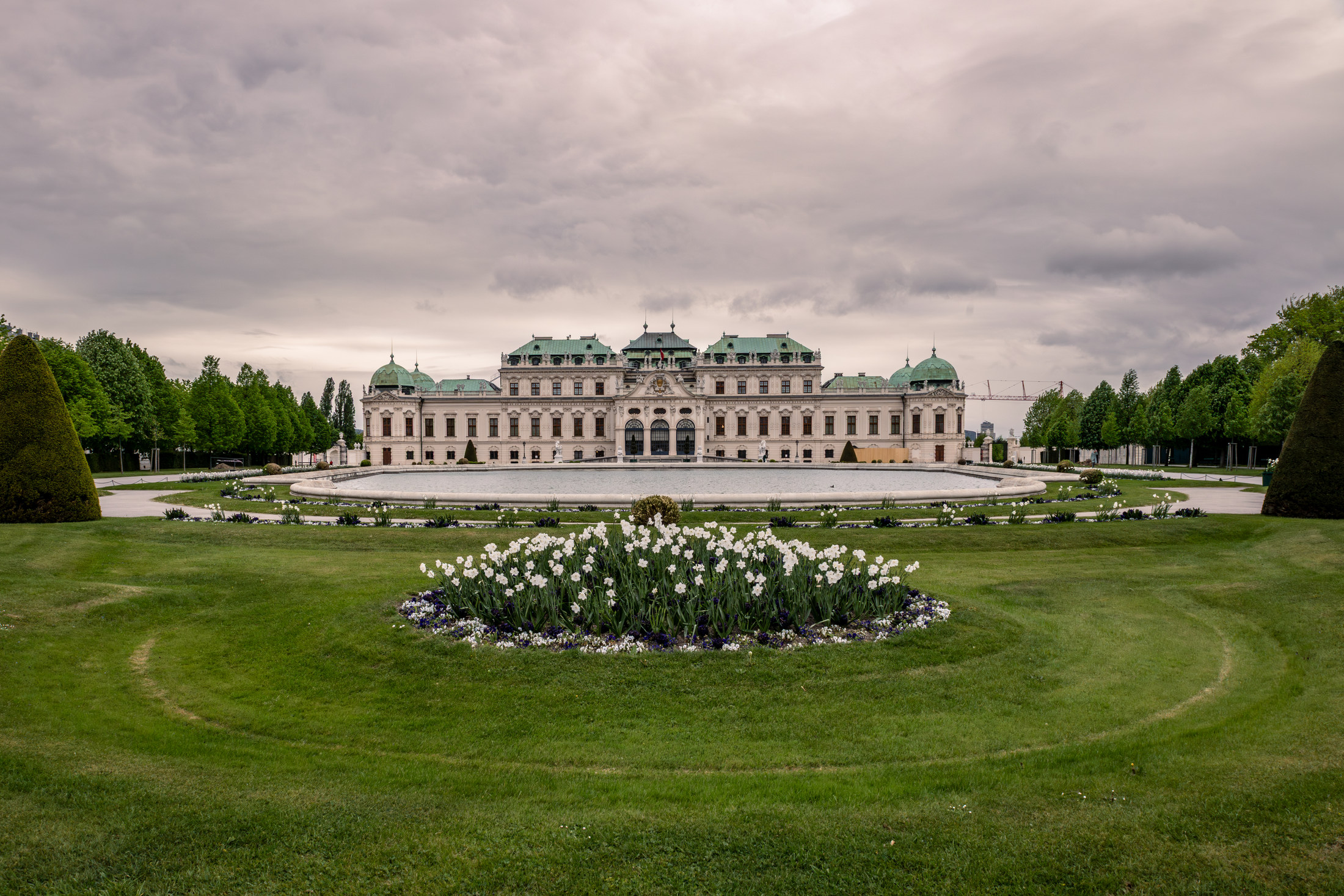Upper Belvedere palace behind a spring flower bed and lawn