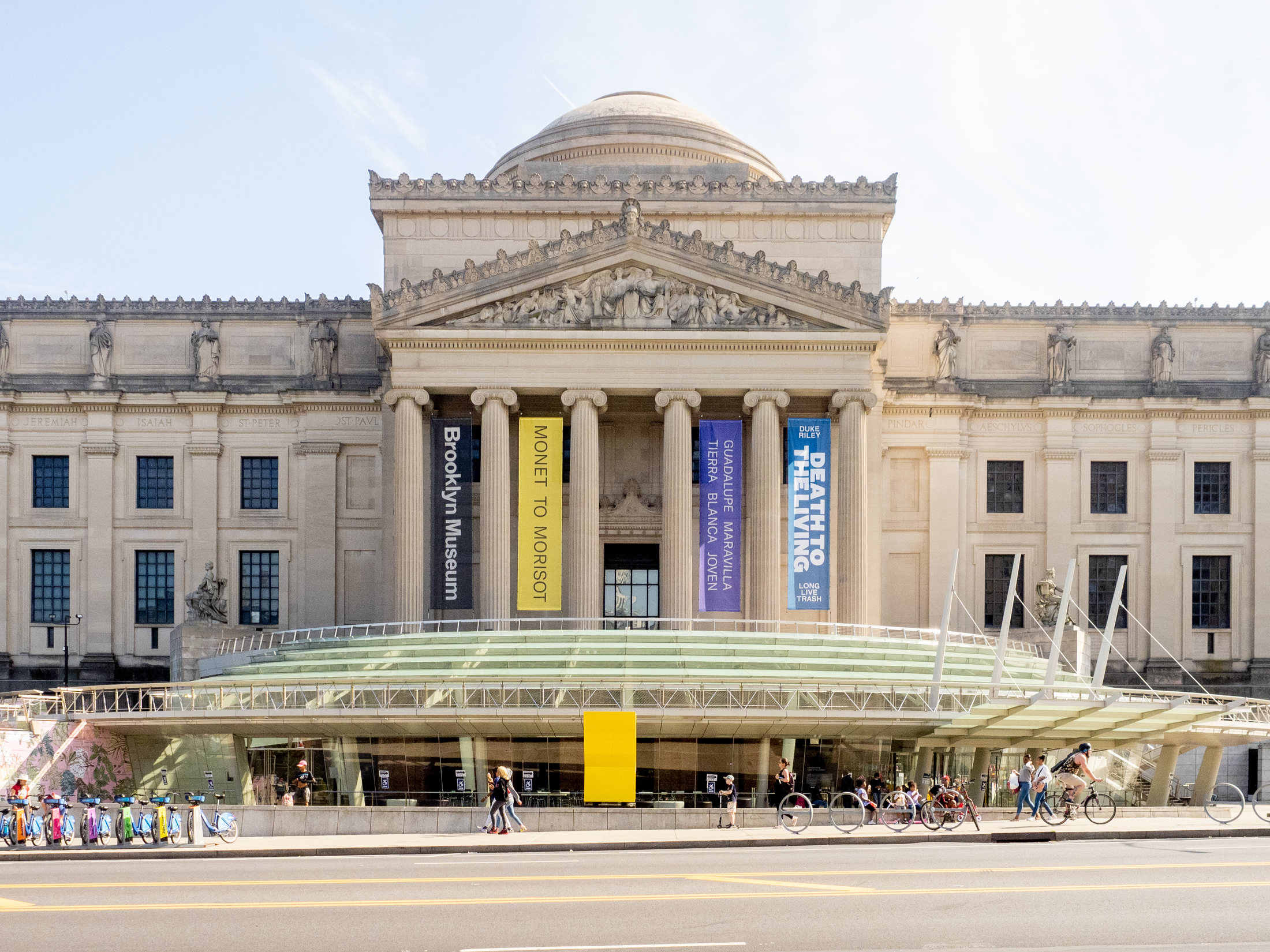 Brooklyn Museum stone façade and glass entrance pavilion viewed across Eastern Parkway