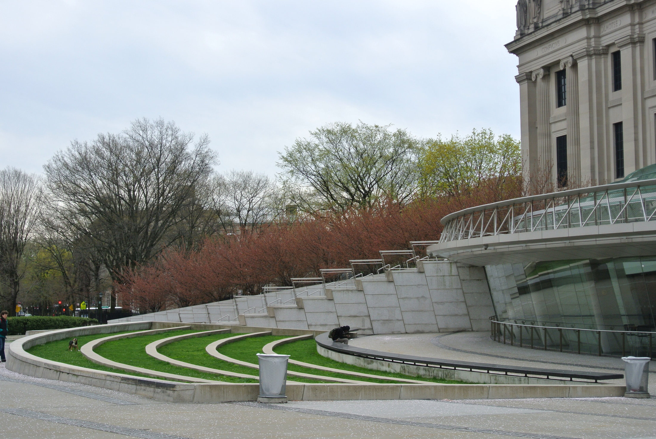 Terraced grassy plaza beside Brooklyn Museum’s glass entrance