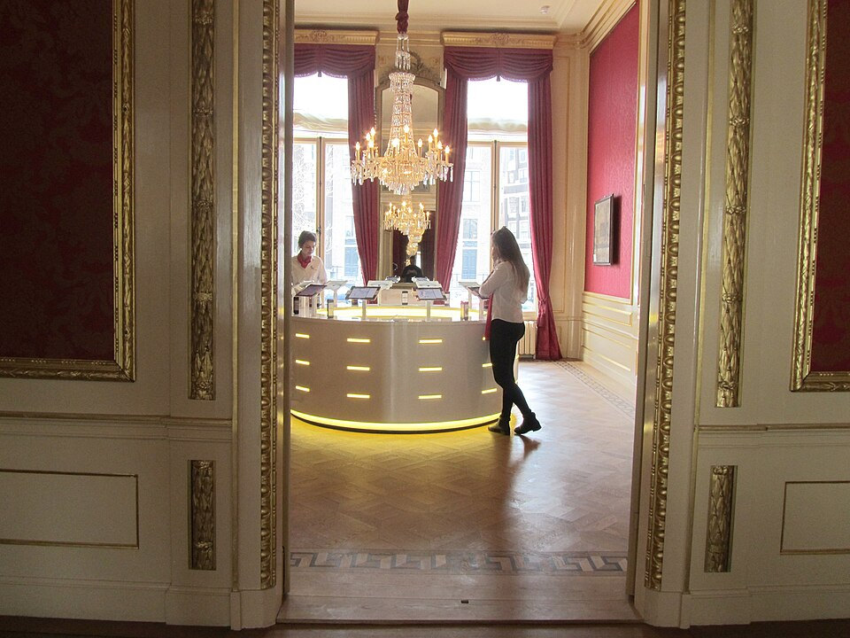 Gilded doorway and red-walled period rooms in the Museum of the Canals
