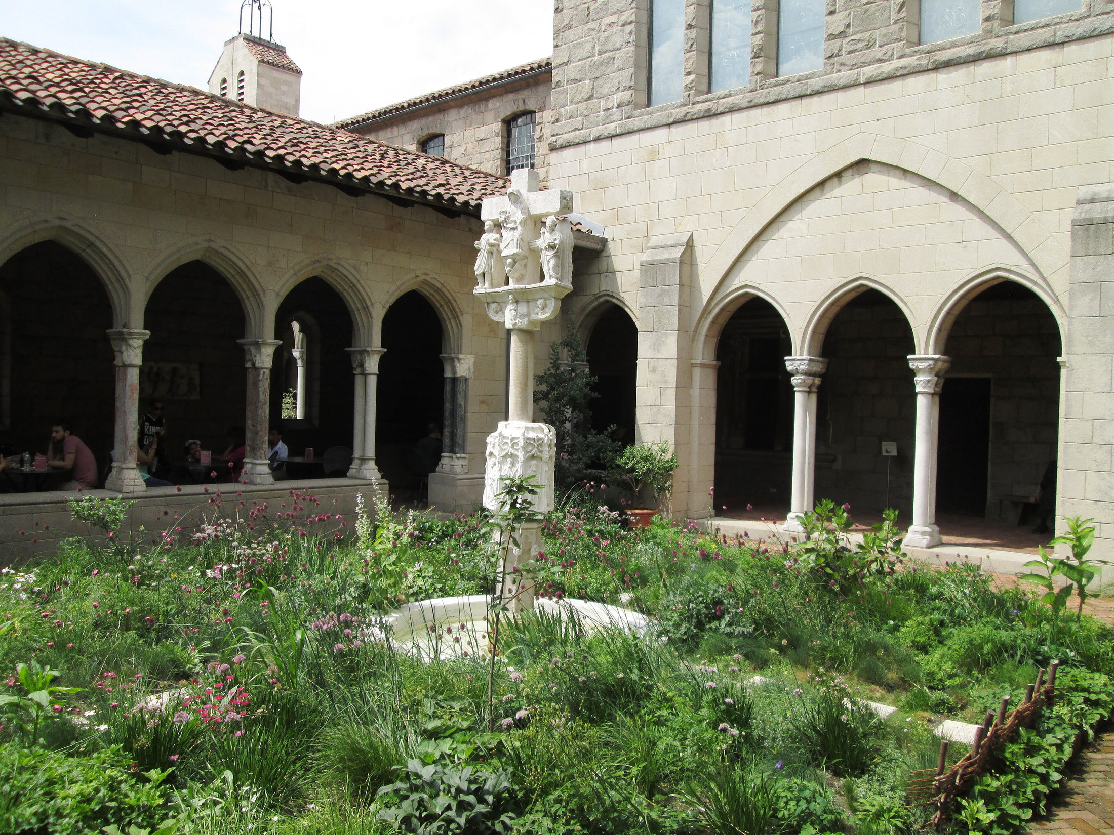 Medieval arcades surrounding the planted Trie Cloister courtyard