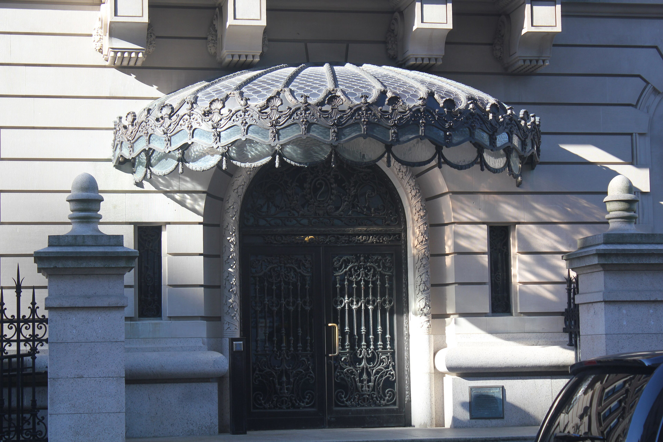 Decorative stonework and glazed canopy over the Carnegie mansion entrance