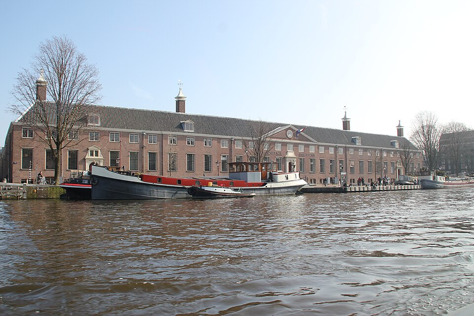 H’ART Museum’s long brick Amstelhof façade viewed across the Amstel