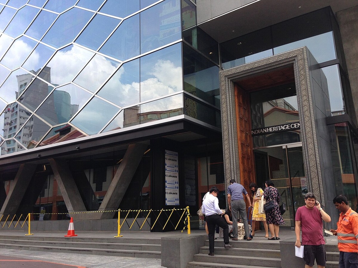 Indian Heritage Centre’s angular glass facade and entrance portal on a street in Little India.