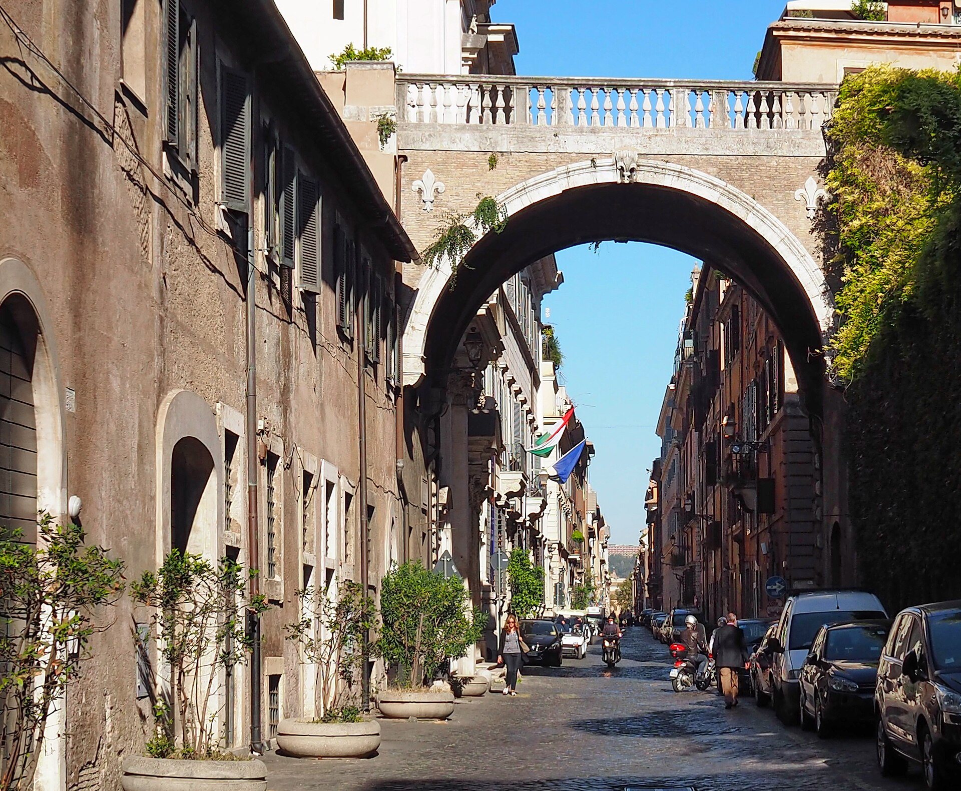 The ivy-covered Farnese Arch spanning Via Giulia in Rome.