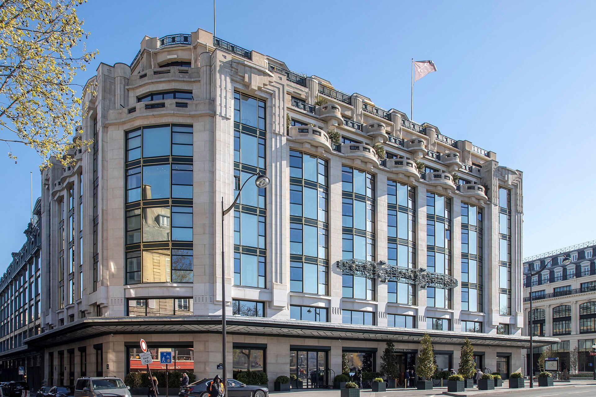 The Art Deco stone facade of La Samaritaine on quai du Louvre under a blue sky.