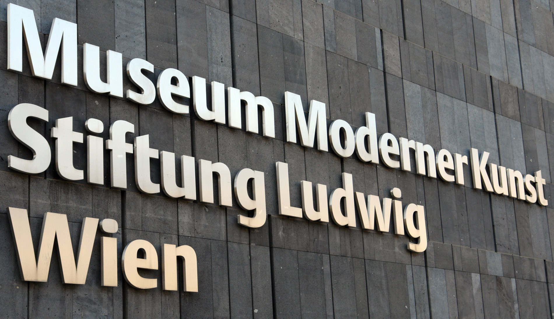 Historic mumok lettering on the museum’s basalt exterior wall