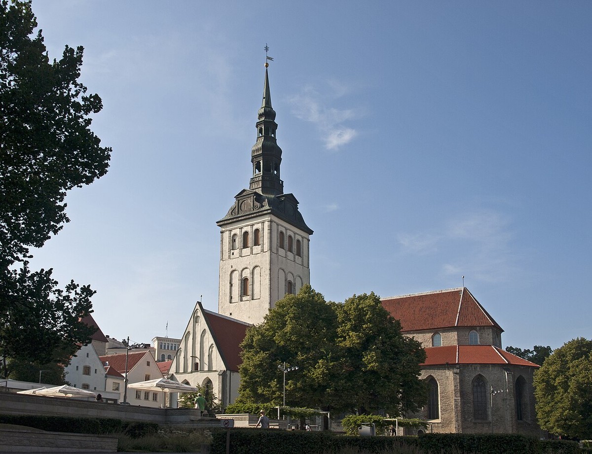 Niguliste’s stone tower and red-roofed church above the surrounding trees.