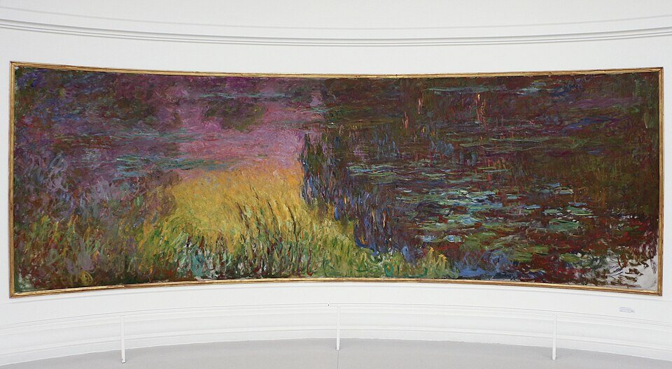 A broad Monet Water Lilies panel displayed on a white curved gallery wall