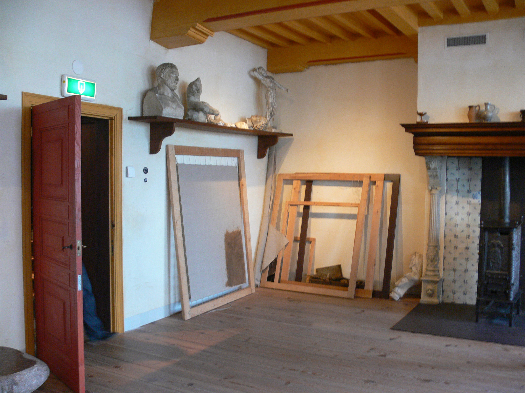 Reconstructed painting studio with easels and a wooden work table in Rembrandt House Museum