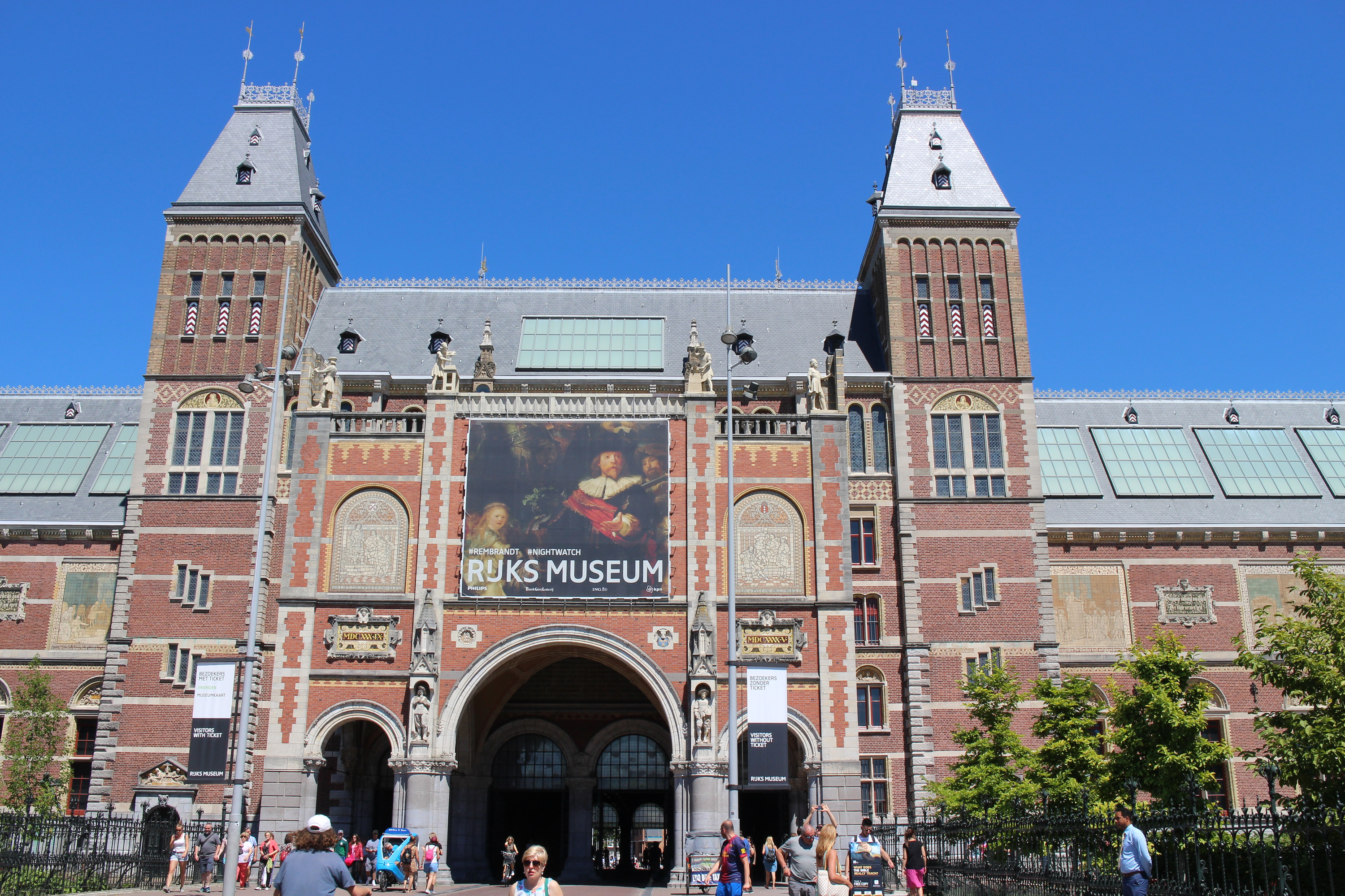 Rijksmuseum’s south entrance and brick towers beneath a blue sky