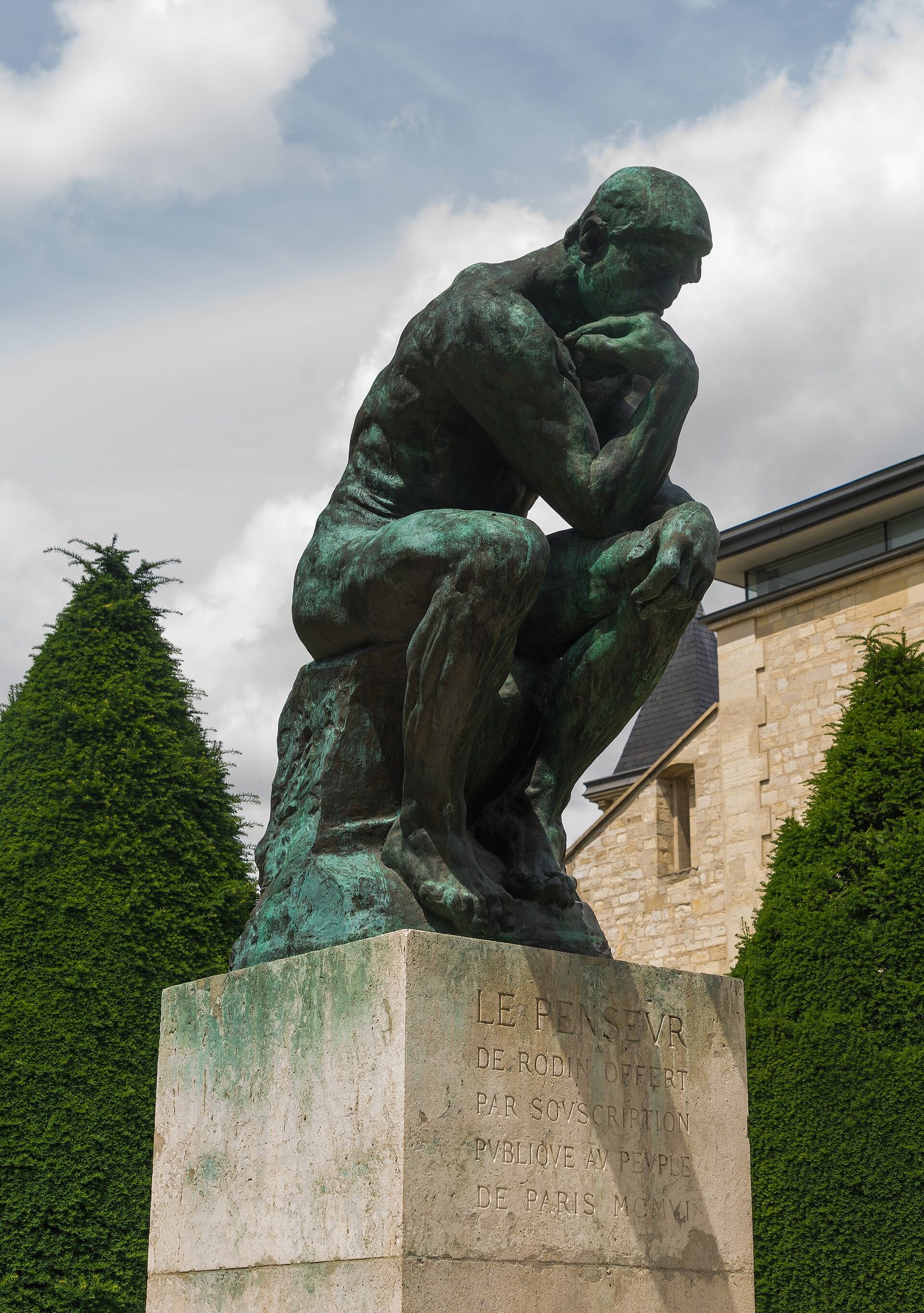 Rodin’s bronze Thinker on a stone pedestal in the Musée Rodin garden