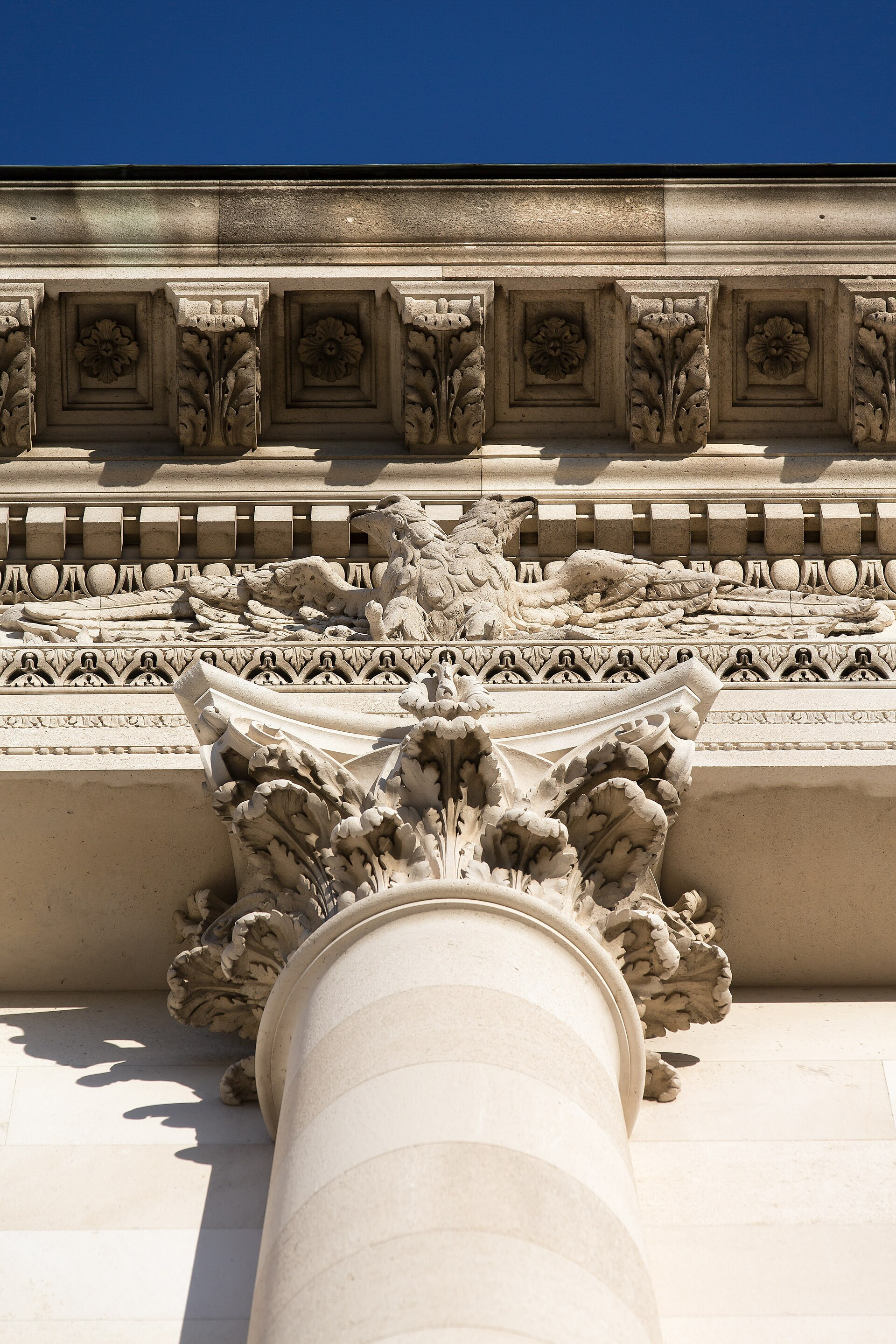 Carved stone capital and eagle frieze on the Weltmuseum Wien façade