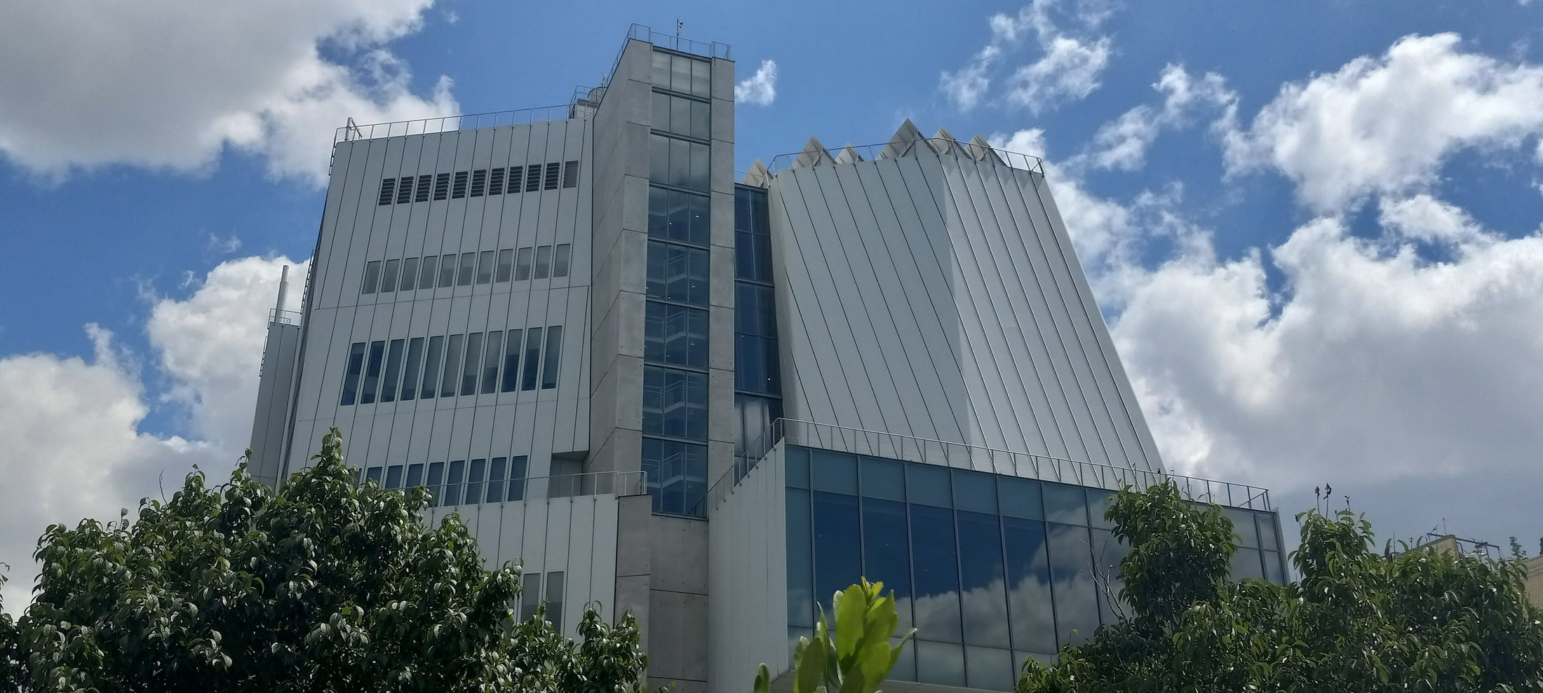 Whitney Museum’s metal-clad river-facing elevation above treetops